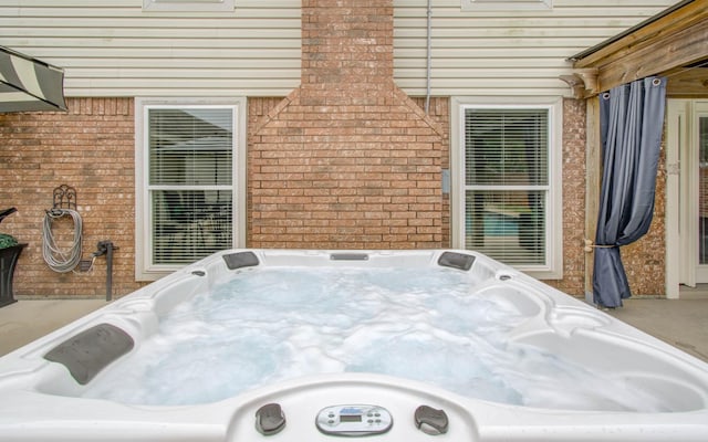 view of patio / terrace with a hot tub