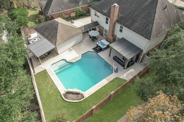 view of swimming pool featuring a lawn and a patio