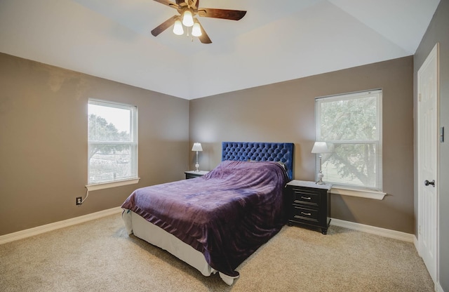 carpeted bedroom featuring vaulted ceiling and ceiling fan