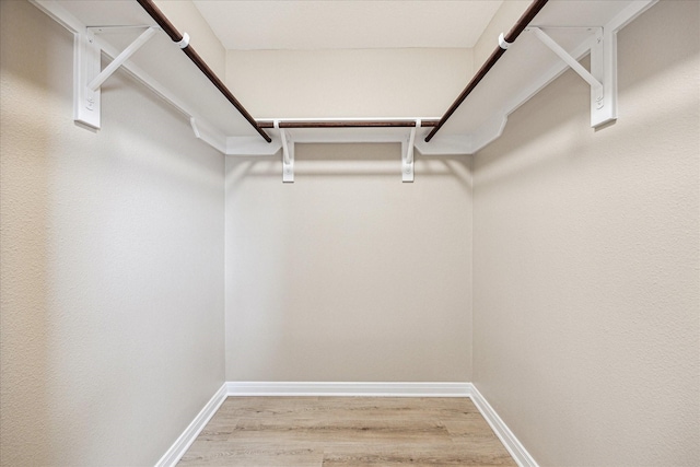 walk in closet featuring hardwood / wood-style floors