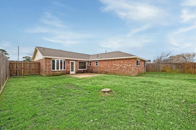 back of house with a yard and a patio area