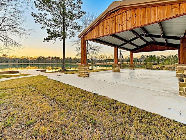 view of community featuring a yard, a water view, and a gazebo