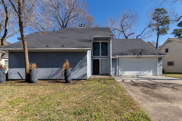 view of front of house with a garage and a front lawn