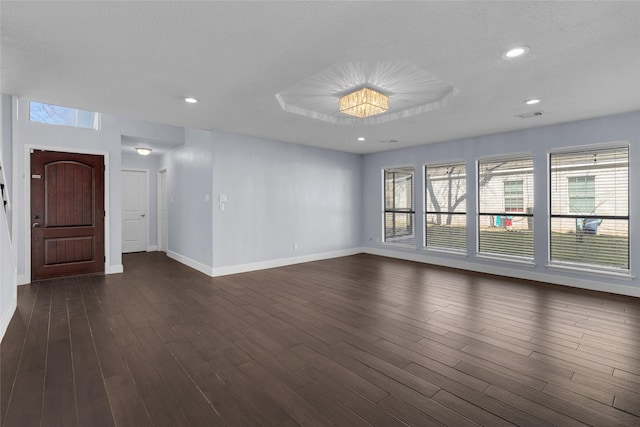 interior space with dark wood-type flooring and a textured ceiling