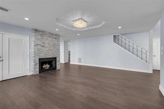 unfurnished living room featuring dark hardwood / wood-style flooring and a fireplace