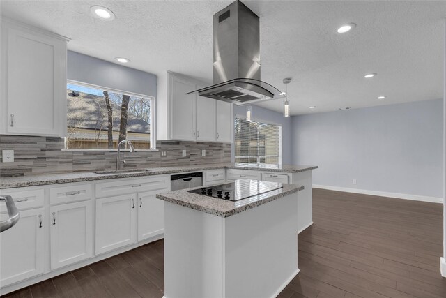 kitchen with sink, white cabinetry, decorative light fixtures, a kitchen island, and island exhaust hood