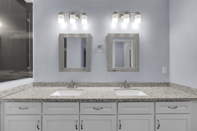 bathroom with vanity and a shower