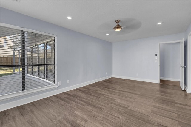 empty room featuring wood-type flooring and ceiling fan