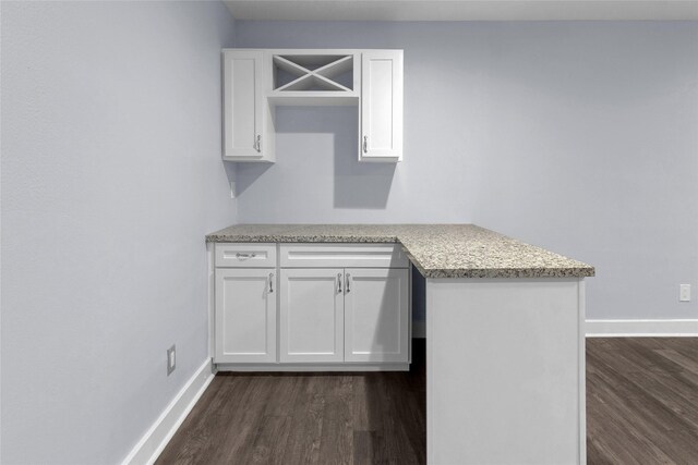 kitchen featuring white cabinetry and dark hardwood / wood-style floors