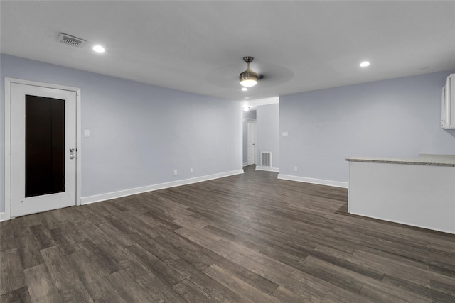 unfurnished living room with dark wood-type flooring and ceiling fan