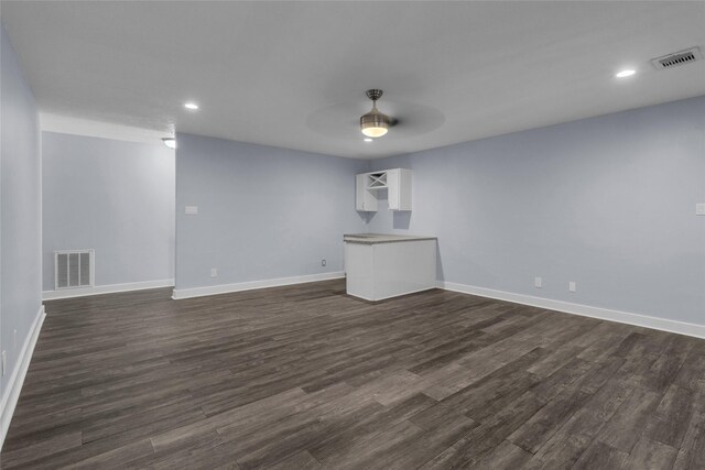 unfurnished room featuring ceiling fan and dark hardwood / wood-style floors