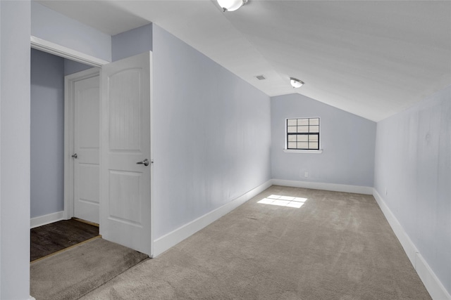 bonus room with lofted ceiling and carpet flooring