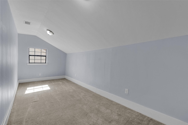 bonus room with lofted ceiling and carpet flooring