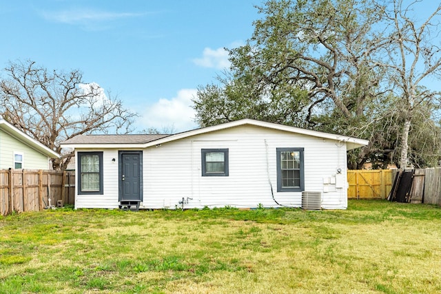 back of house featuring a yard and cooling unit