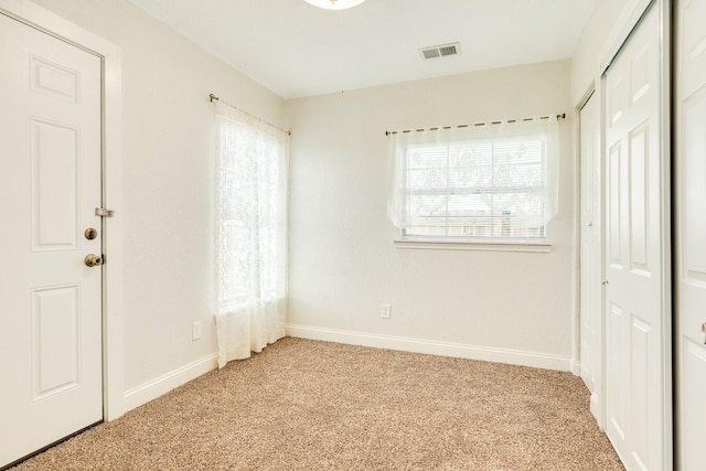 unfurnished bedroom featuring light colored carpet