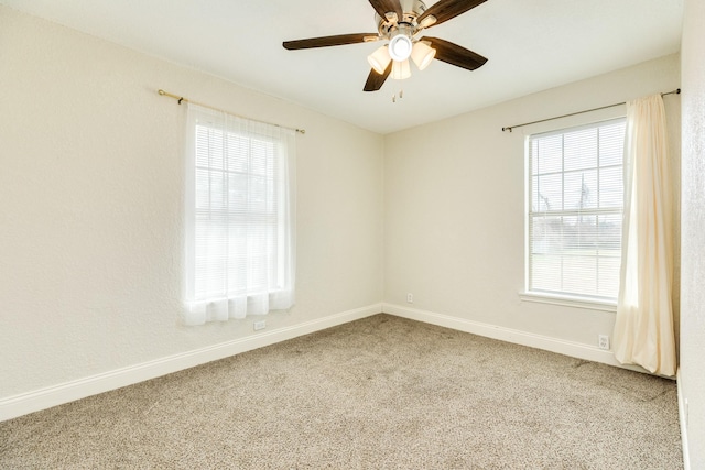 empty room featuring carpet floors and ceiling fan