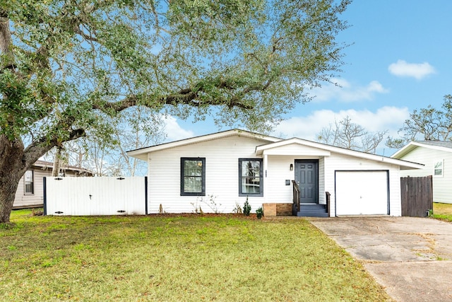 view of front of home featuring a garage and a front lawn