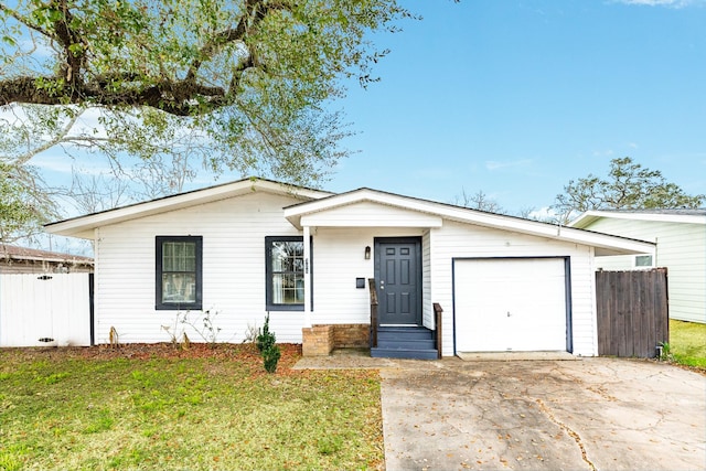 ranch-style home with a garage and a front yard