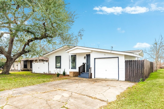 ranch-style house with a garage and a front lawn