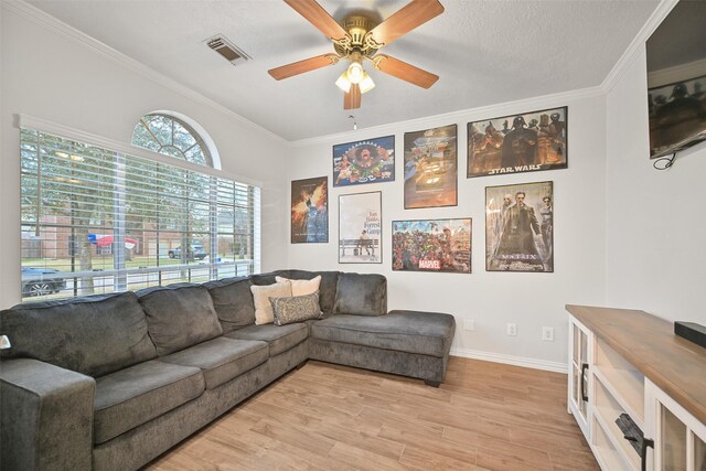 living room featuring crown molding, a textured ceiling, ceiling fan, and light hardwood / wood-style floors