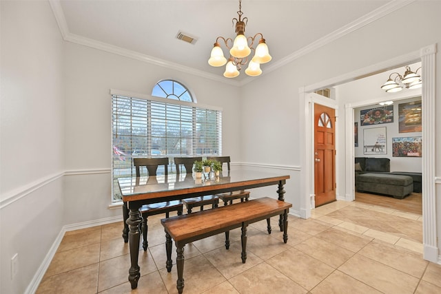 dining area featuring ornamental molding, light tile patterned flooring, and a chandelier