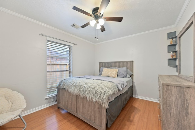 bedroom with hardwood / wood-style flooring, ceiling fan, crown molding, and a textured ceiling