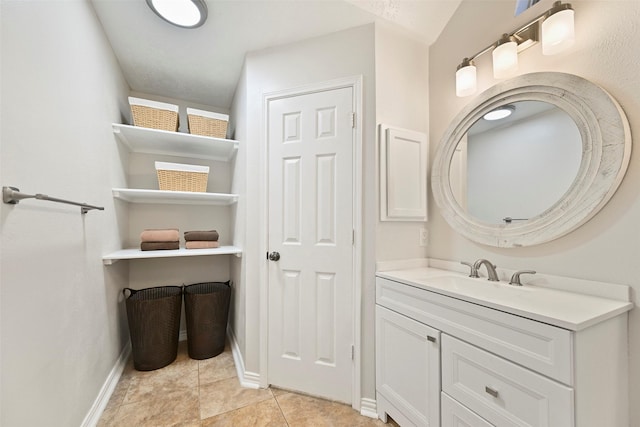 bathroom featuring tile patterned flooring, vanity, and baseboards