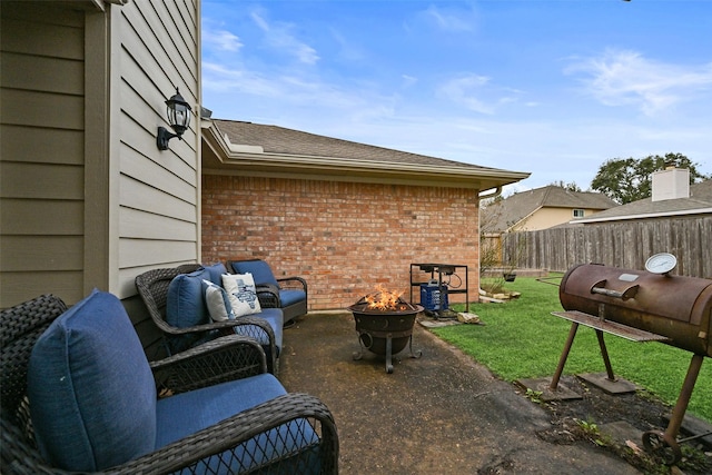 view of patio / terrace featuring fence and a fire pit