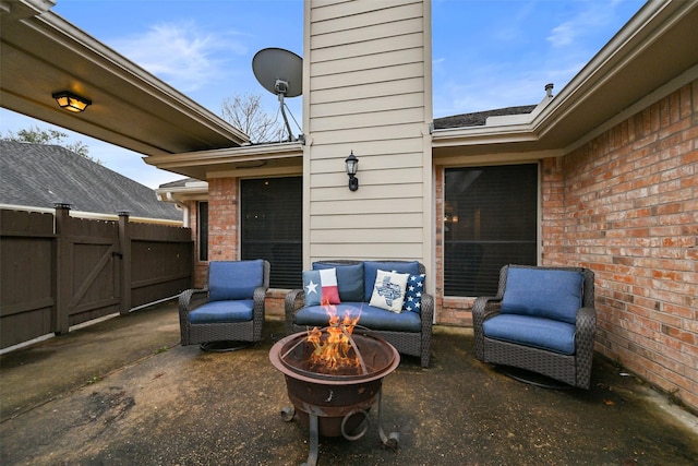 view of patio with a gate, fence, and a fire pit