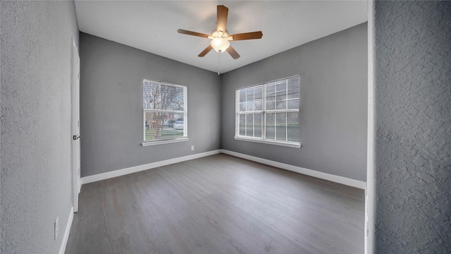 spare room featuring dark hardwood / wood-style floors and ceiling fan