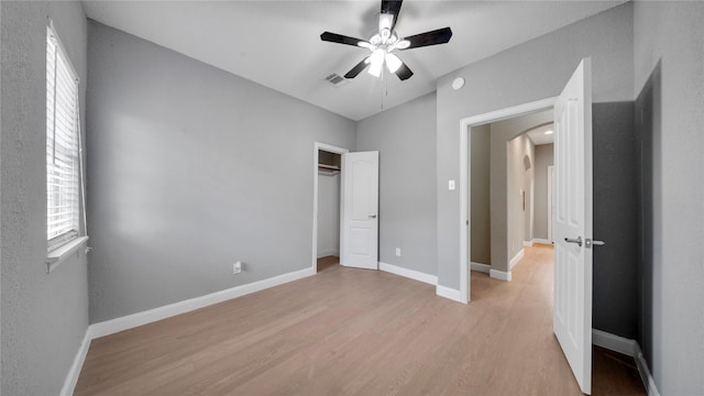 unfurnished bedroom with ceiling fan, light hardwood / wood-style floors, and a closet