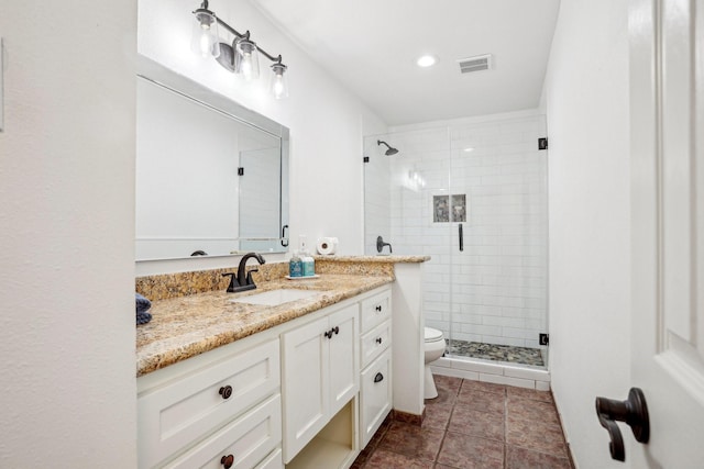 bathroom with tile patterned flooring, vanity, walk in shower, and toilet