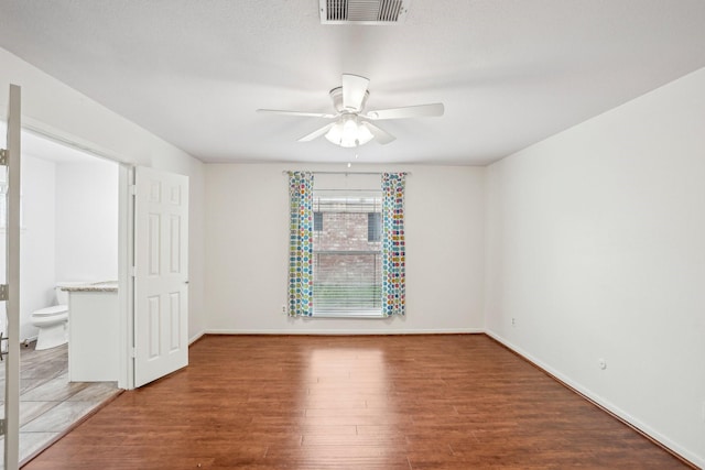 empty room featuring hardwood / wood-style flooring and ceiling fan