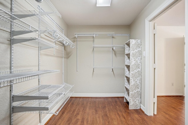 walk in closet featuring hardwood / wood-style flooring