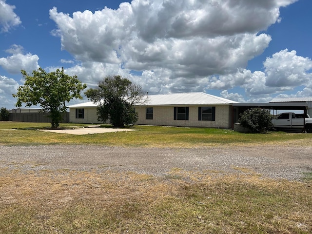 single story home with a carport and a front yard