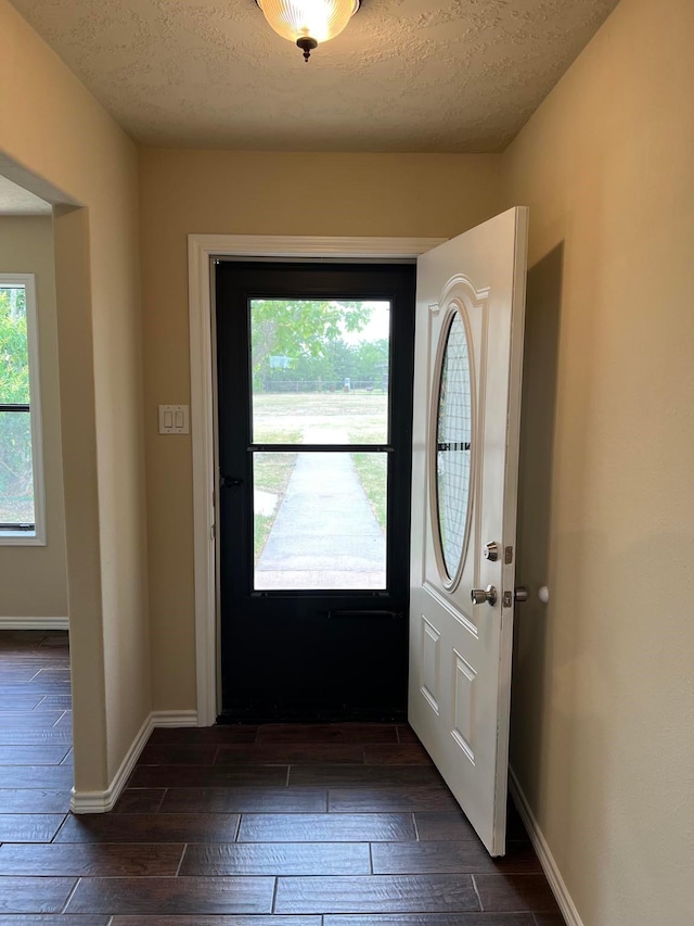 foyer entrance featuring a textured ceiling