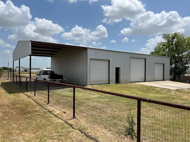 view of outbuilding with a garage and a lawn