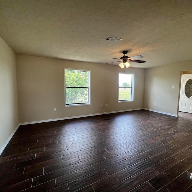 spare room with ceiling fan and a textured ceiling