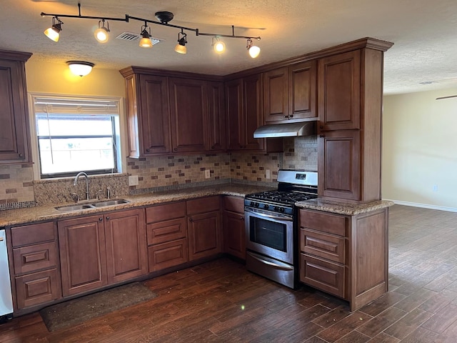 kitchen featuring stainless steel range with gas cooktop, sink, dark wood-type flooring, and a textured ceiling