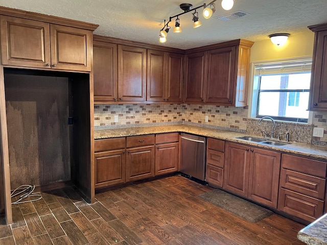 kitchen with sink, dishwasher, backsplash, light stone counters, and dark hardwood / wood-style flooring