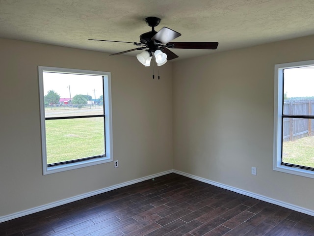 spare room with ceiling fan, a textured ceiling, and dark hardwood / wood-style flooring