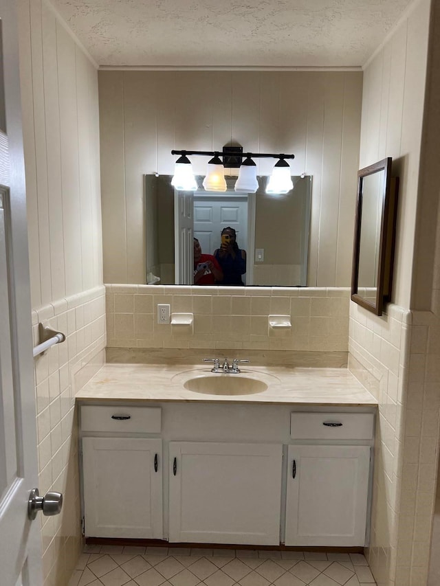 bathroom featuring vanity, tile patterned flooring, and a textured ceiling