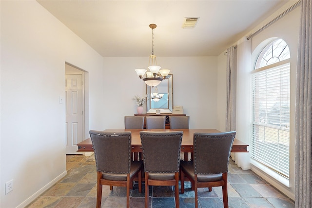 dining area with a notable chandelier