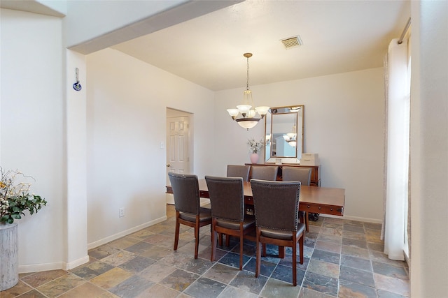 dining space with a notable chandelier