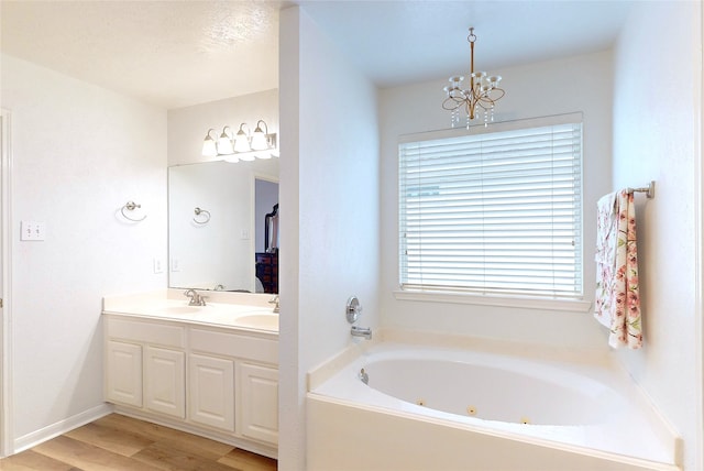 bathroom with vanity, a bathtub, wood-type flooring, and a chandelier