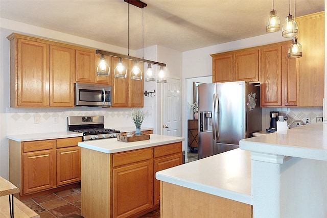 kitchen featuring hanging light fixtures, appliances with stainless steel finishes, a center island, and decorative backsplash