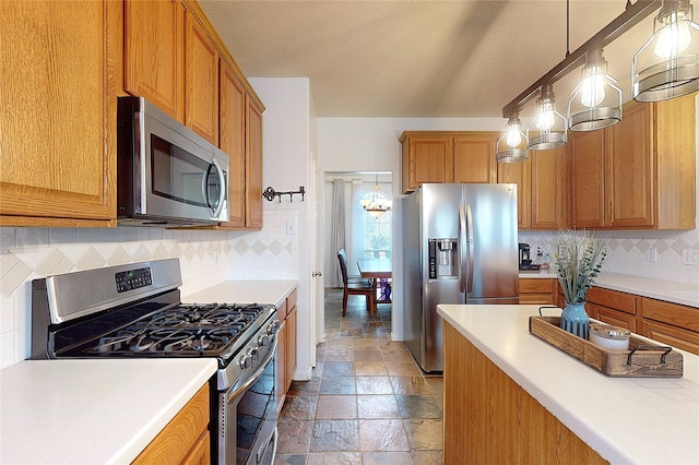 kitchen with tasteful backsplash, appliances with stainless steel finishes, hanging light fixtures, and a textured ceiling