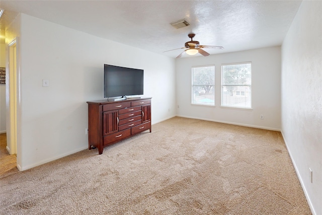 living room featuring a textured ceiling, light colored carpet, and ceiling fan