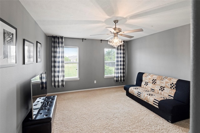 living area featuring carpet, a textured ceiling, and ceiling fan