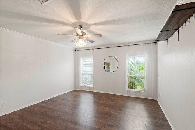 unfurnished room with crown molding, a textured ceiling, dark hardwood / wood-style floors, and ceiling fan